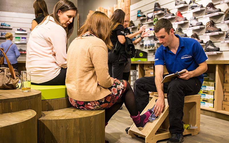 Cotswold outdoor team member helping take size of feet of lady in Webbs Wychbold store